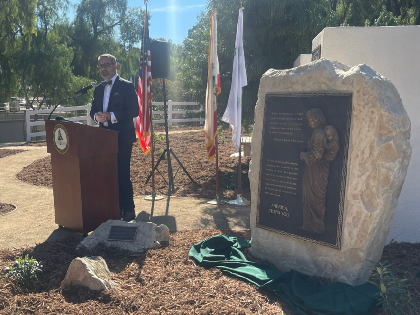 Frank Zerunyan in front of Rolling Hills Estates, California Genocide Memorial Monument that says “America, Thank you”